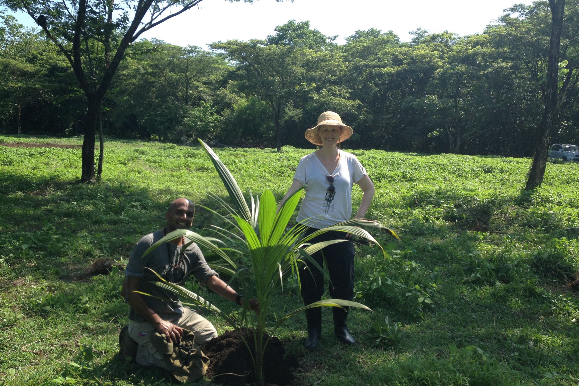 Dandapani and Tatiana with the first tree, a coconut palm, May 2014