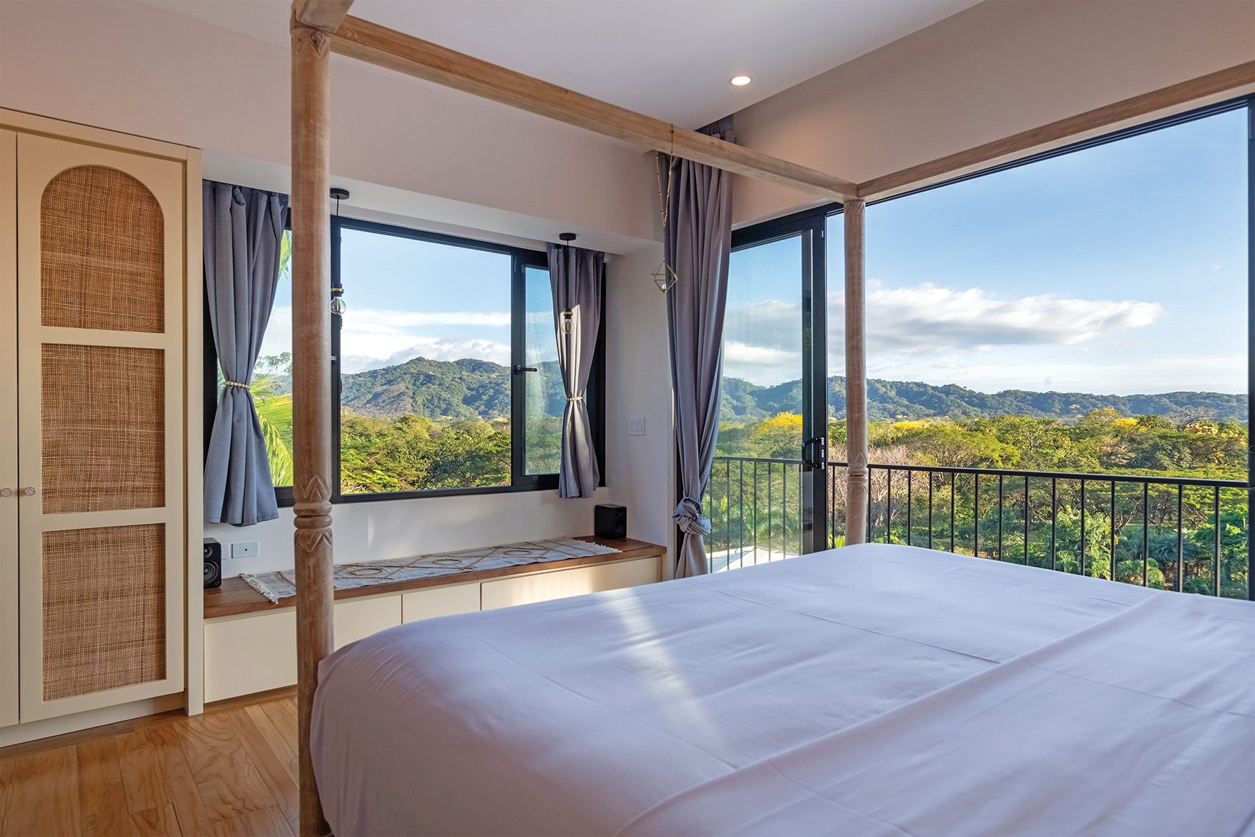 Bedroom with a four-poster bed and window seat