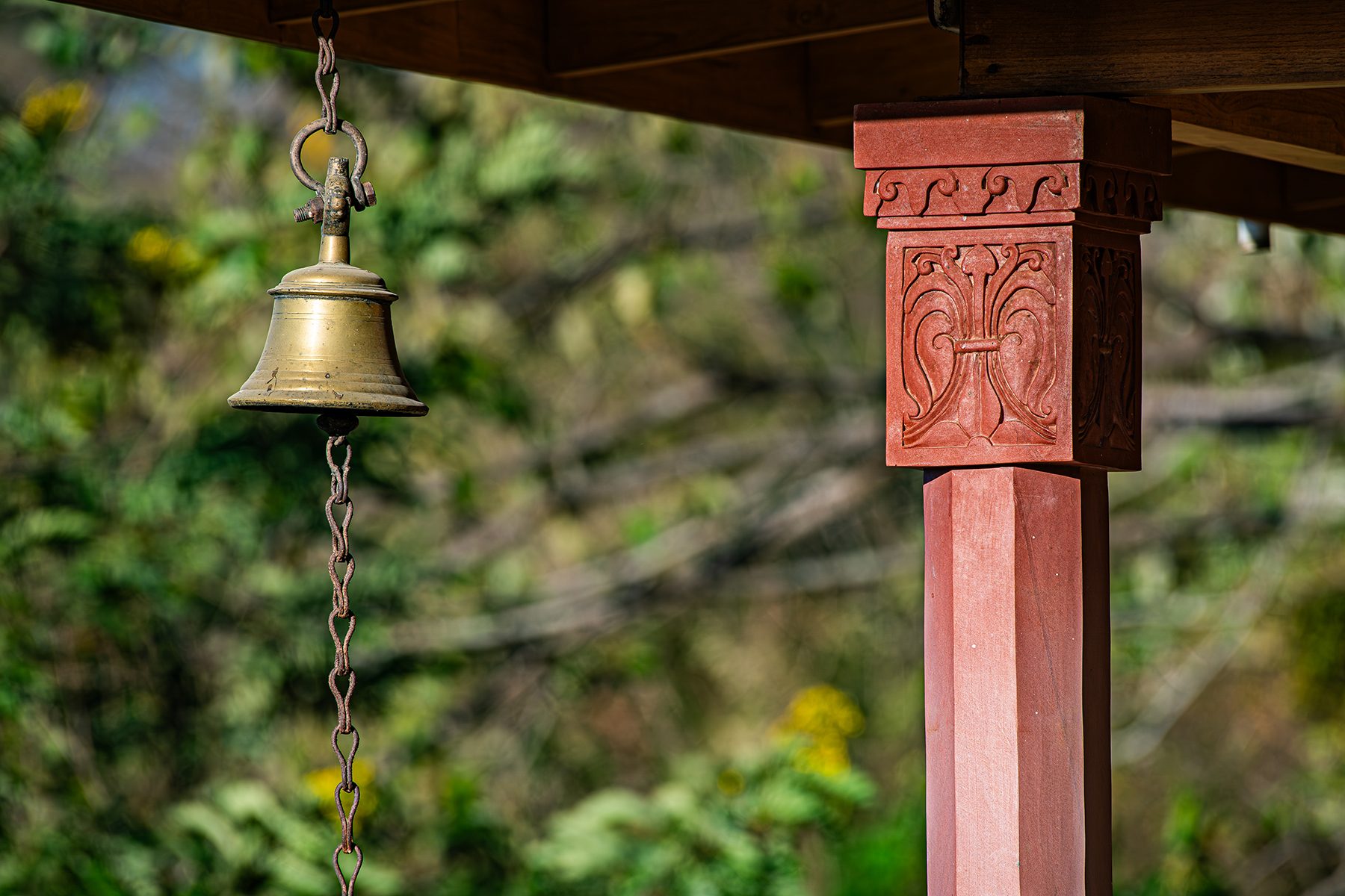 Carved pink sandstone pillar on the veranda