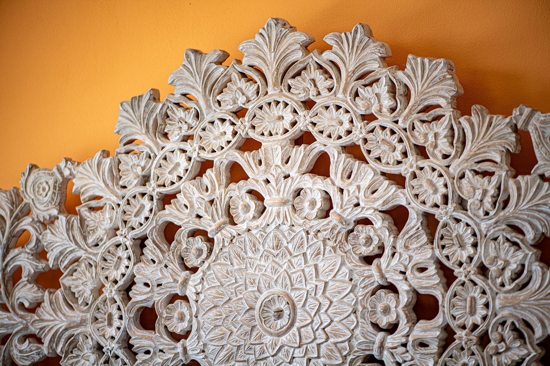 Carved mandala headboard detail — The Sanctuary Estate, Nosara, Costa Rica