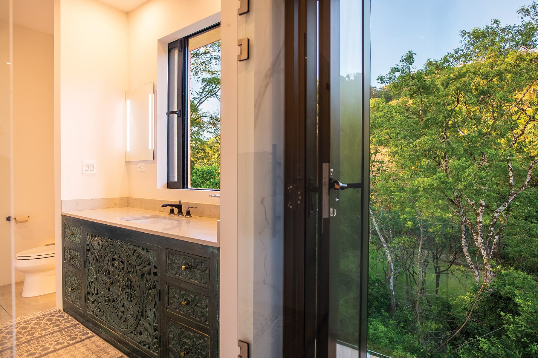 Bathroom vanity forest view — The Sanctuary Estate, Nosara, Costa Rica